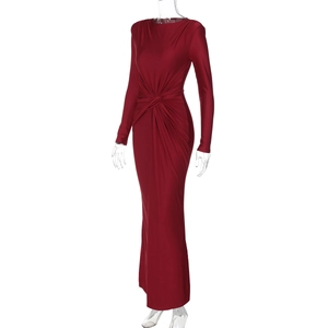 Detail of red floor-length evening gown featuring elegant waist twist and ruched silhouette