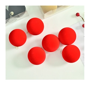 Detail of six red flocked velvet Christmas ornaments with golden metal hanging loops