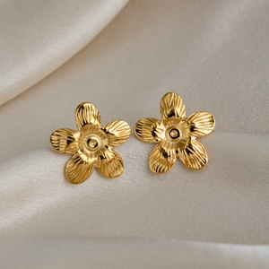 Elegant 18K gold plated flower stud earrings with brushed texture on white silk backdrop