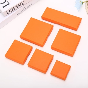 Detail of orange textured jewelry boxes in various square and rectangular sizes