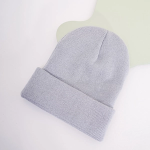 Close-up of light blue knitted beanie with soft texture and classic fold-up cuff design