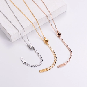 Detailed macro view of adjustable necklace chains with lobster clasps in gold and silver