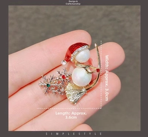 Detail of Christmas snowman brooch with red enamel, pearls, and jewels, 3.0cm x 3.6cm size