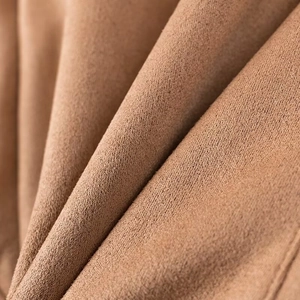 Macro shot of brown suede fabric showing soft texture and premium material detail