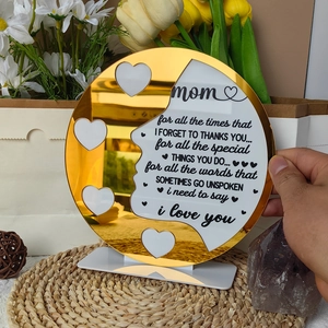 Macro shot of acrylic Mother's Day plaque with gold mirror and four heart photo frames