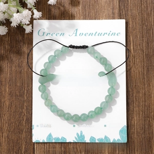 Detail of Green Aventurine beaded bracelet on adjustable cord with description card