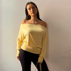 Slim fit yellow long sleeve off-shoulder top for women paired with black trousers