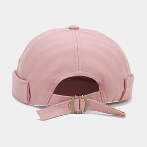 Detail of adjustable metal buckle and strap on pink vintage docker cap for custom fit