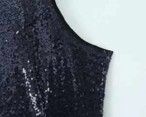 Detailed macro view of dark blue sequins on the backless sexy party dress fabric