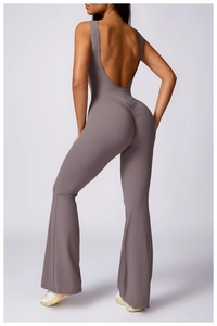 Detailed back view of a taupe backless yoga jumpsuit with scrunch butt and flare legs