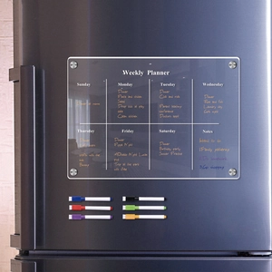 Close-up of magnetic acrylic weekly planner on fridge with six colorful markers