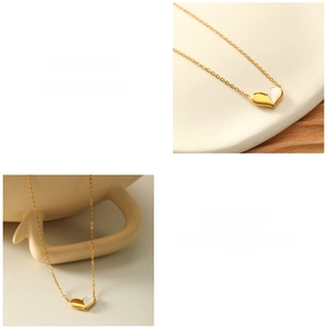 Close-up of heart pendant necklace with gold metal and white shell inlay detail