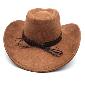 Close-up of brown suede western cowboy hat with leather band and metal rivets
