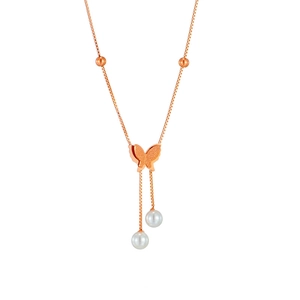 Detail of rose gold necklace featuring a butterfly pendant and hanging white pearls