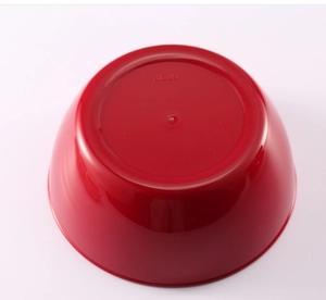 Detail view of red 3-cup plastic bowl base showing capacity markings and smooth finish