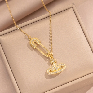 Luxurious gold Saturn orb and safety pin necklace with micro-pave zircons on satin
