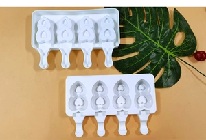 Detailed view of white 4-cavity heart silicone ice cream mold with matching lids