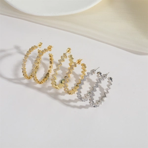 Minimalist C-shaped wave earrings with embedded cubic zirconia in gold and silver finish
