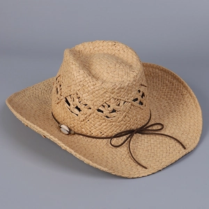 Detail of straw cowboy hat featuring diamond mesh weave and a natural seashell accent