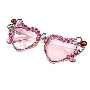 Y2K heart-shaped sunglasses with pink rhinestones and tinted lenses on white background