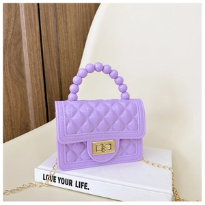 Detail of purple quilted jelly bag featuring a beaded handle and golden chain strap