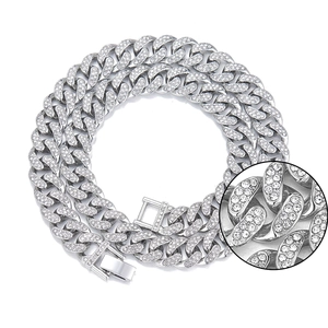 Macro detail of iced-out silver Cuban link chain with sparkling diamond-set links