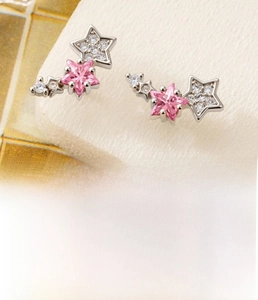 Détail macro du clou d'oreille étoile avec zircon rose et guide des dimensions