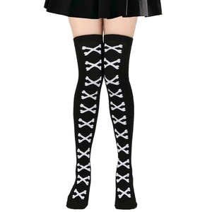 Detail of gothic thigh high socks featuring white crossbone patterns for Halloween costumes