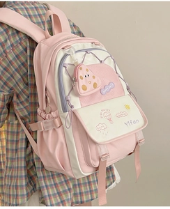Pink and white lightweight nylon school backpack with a mushroom pendant and side pockets