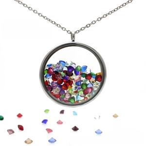 Close-up of a round silver locket pendant filled with colorful faceted crystals
