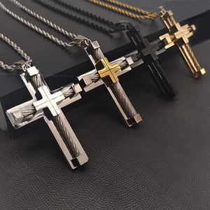 Detail of cross pendants with wire rope inlay in silver, gold, and black steel finishes