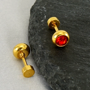 Detail of gold-plated stainless steel stud earrings with brilliant red cubic zirconia