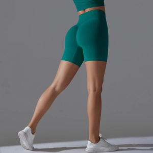 Detailed back view of high-waisted seamless scrunch butt yoga shorts in dark teal green