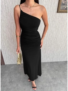 Detail view of black one-shoulder ruched dress with slimming fit and long length