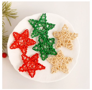 Macro detail of handmade rattan star ornaments in red, green and natural colors for Christmas