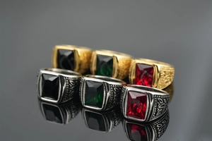 Detailed view of vintage titanium steel rings with red, green and black gemstones