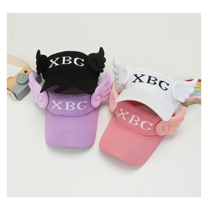 Flat lay of colorful knitted kids' visor hats with XBG embroidery and wing details