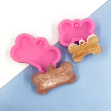 Detailed view of pink silicone bone molds for DIY resin keychains and pendants