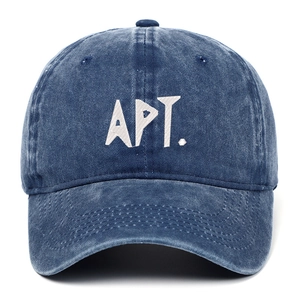 Detail of white APT. embroidery on navy blue washed denim baseball cap with visor stitching