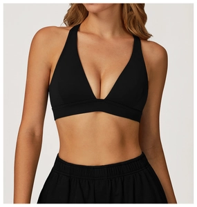 Detail of a black deep V-neck halter sports bra with a wide elastic bottom band