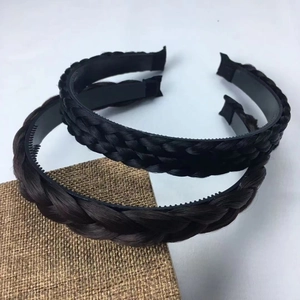 Detail of twisted braid headbands in black and brown with non-slip inner teeth