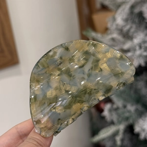 Elegant marble texture acetate claw clip in green and yellow for stylish hair styling