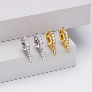 Macro detail of S925 sterling silver hoop earrings with clear zircon pavé in gold and silver