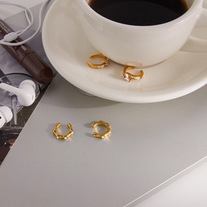 Close-up of 18K gold-plated stainless steel ear cuffs with sparkling round rhinestones