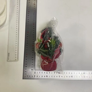 Mini artificial Christmas tree with red glitter balls and red fabric base for table decor