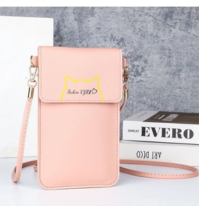 Detail view of pink leather crossbody phone bag with yellow cat ear design and strap