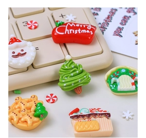 Close-up of festive Christmas resin charms including Santa and trees for DIY crafts