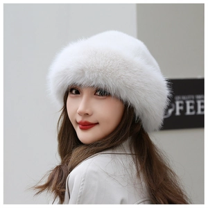 Detail view of a white faux fur beret hat showing soft texture and fluffy warmth