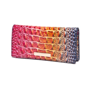 Detail of gradient crocodile pattern leather and golden metal bar on long wallet