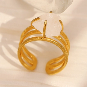 Close-up of 18K gold plated hammered ring with inlaid white natural stone detail